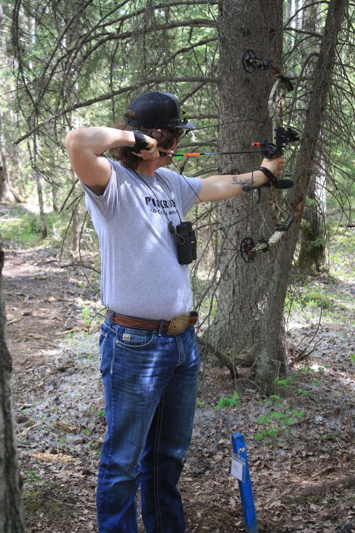 Archer shooting arrow at target