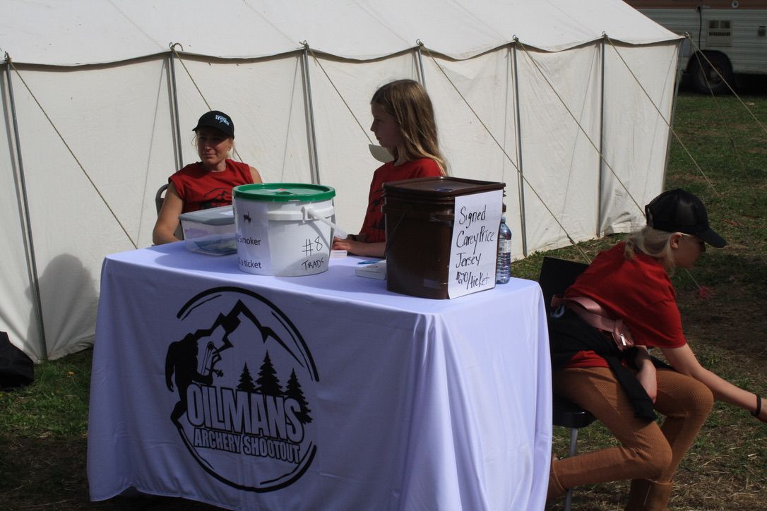 People sitting at a table with a sign that says mountains health