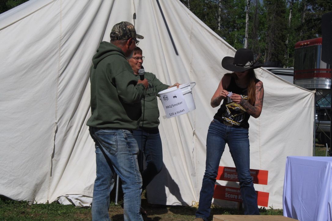 A man and a woman are standing in front of a tent
