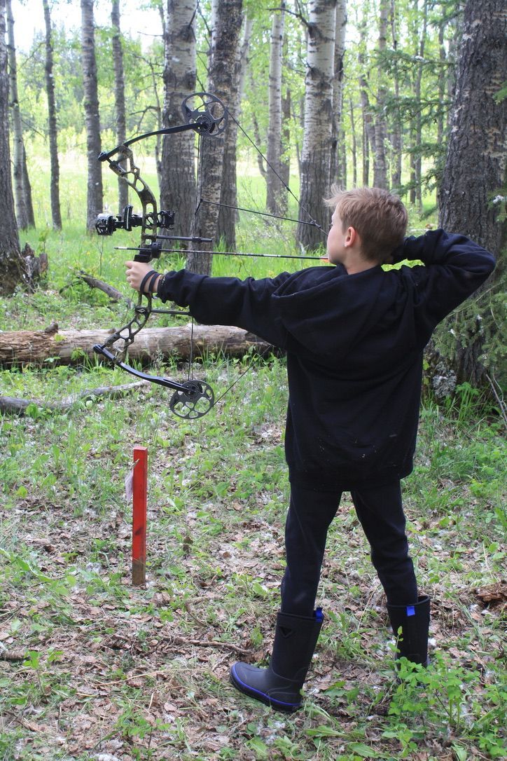 Archer shooting arrow at target