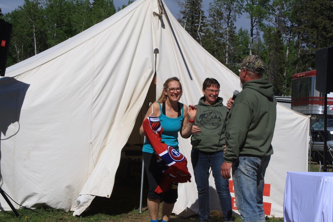 A group of people standing in front of a tent