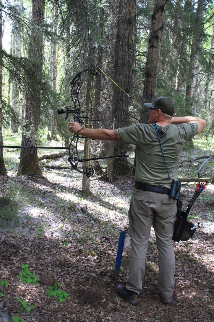Archer shooting arrow at target