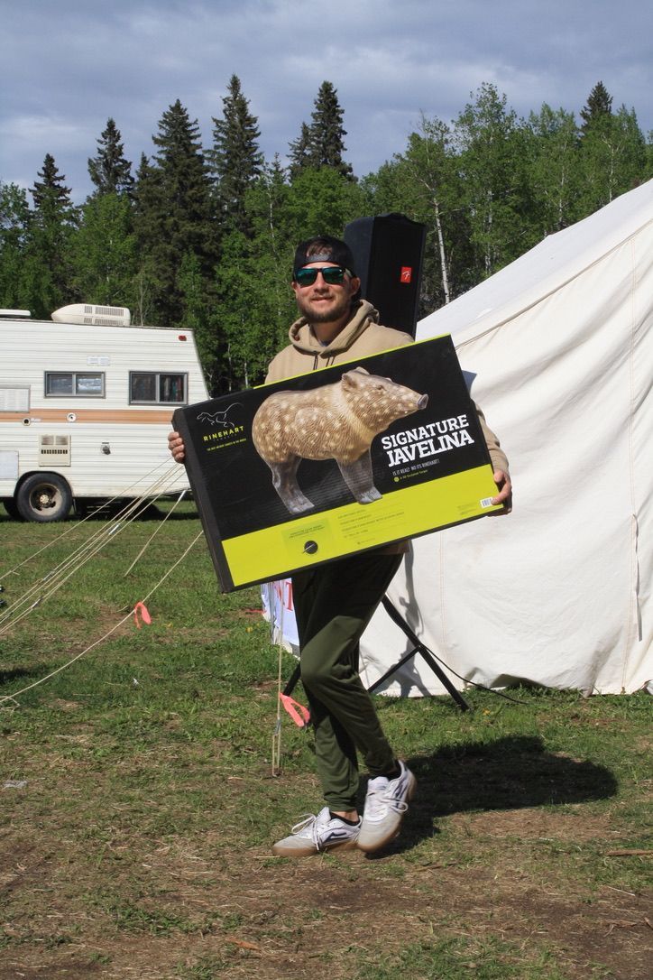A man is holding a box with a picture of a capybara on it.