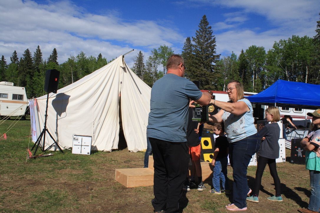 A group of people are standing in front of a tent.