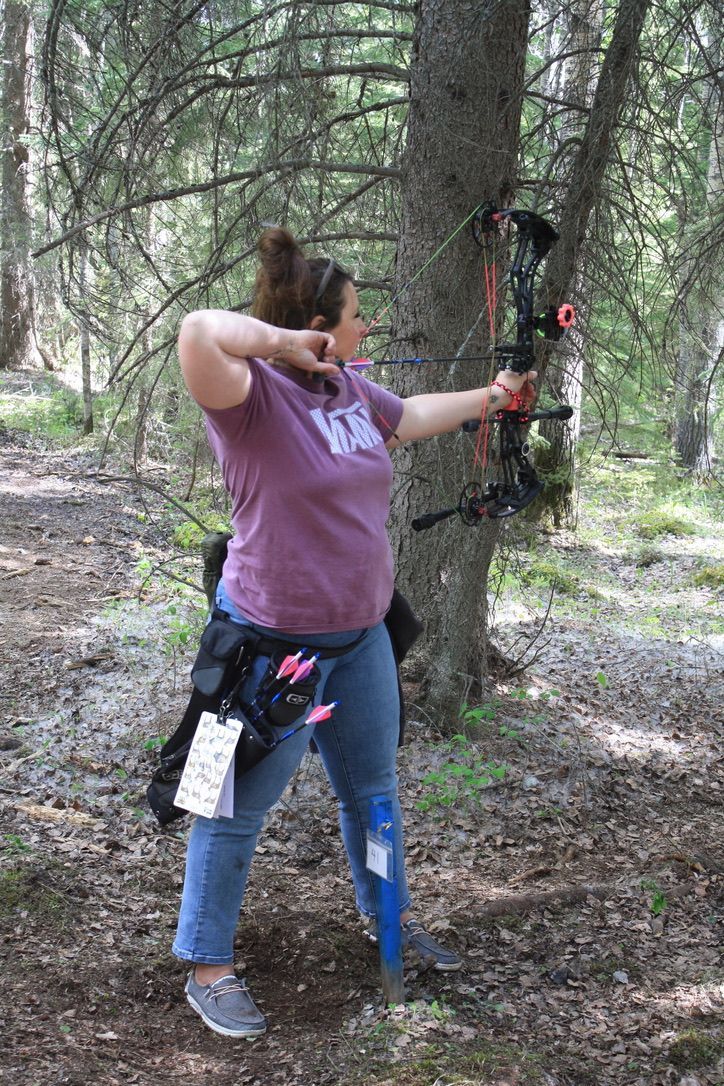 Archer shooting arrow at target