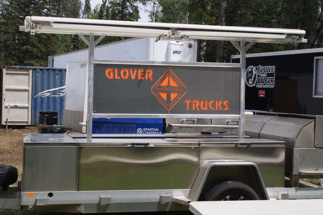 A trailer with a sign that says glover trucks on it