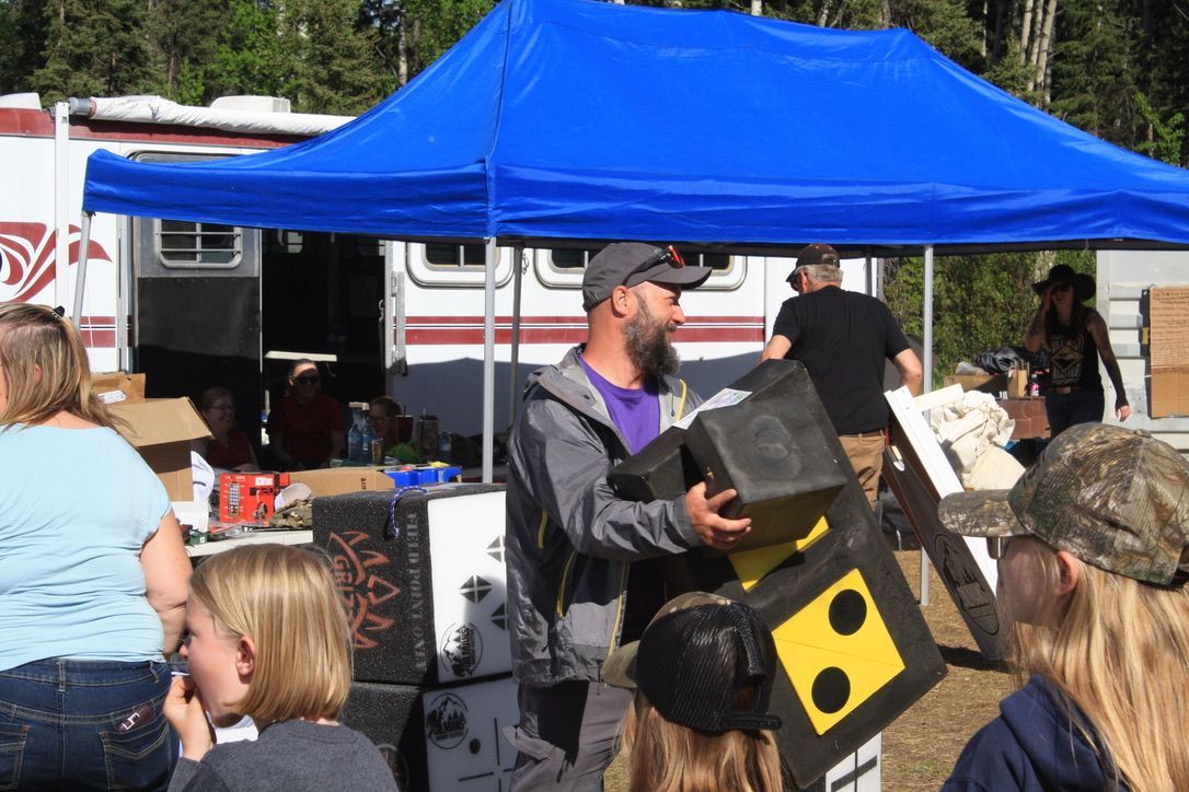 A man is holding a box with the number 8 on it