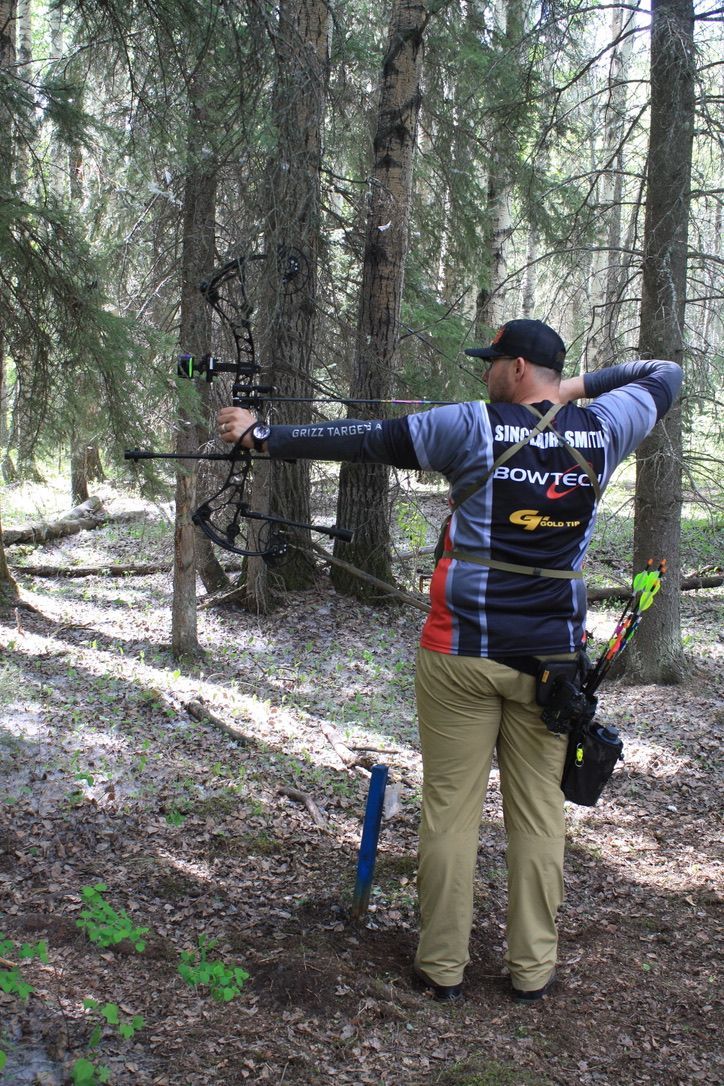 Archer shooting arrow at target