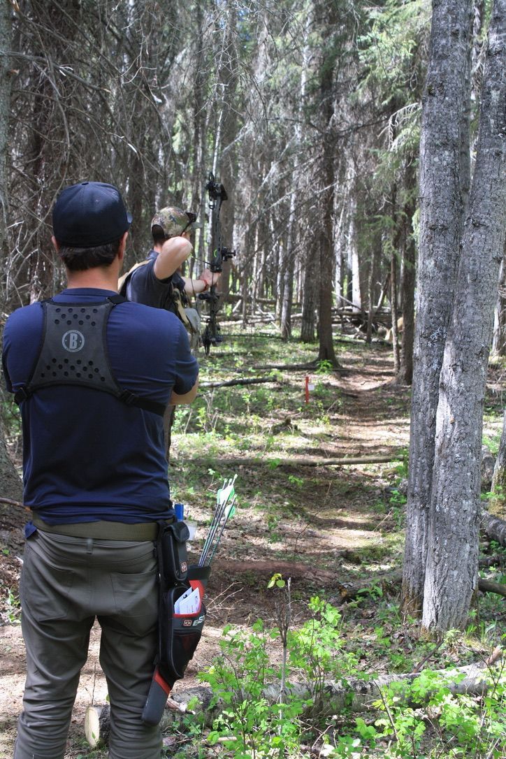 Archer shooting arrow at target