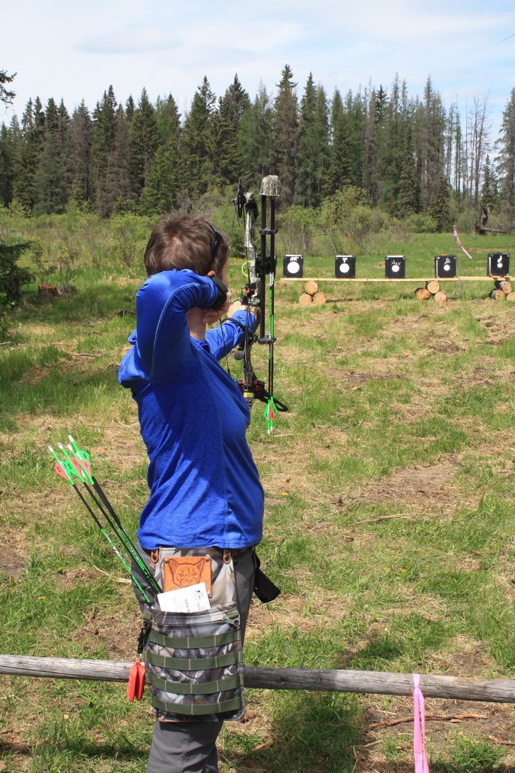 Archer shooting arrow at target