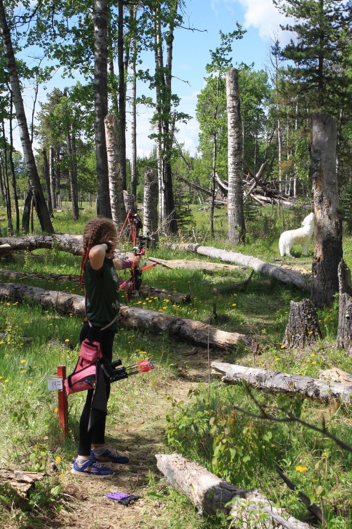 Young girl shooting at target.