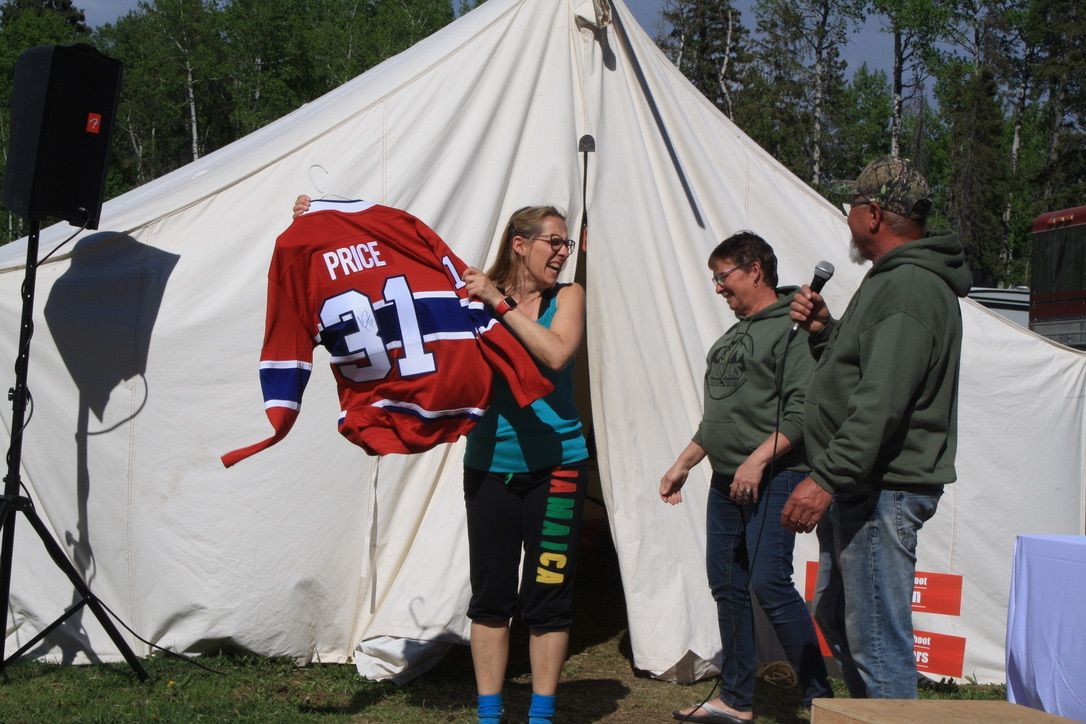 A woman is holding up a jersey with the number 31 on it