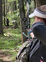 Man shooting arrow at target