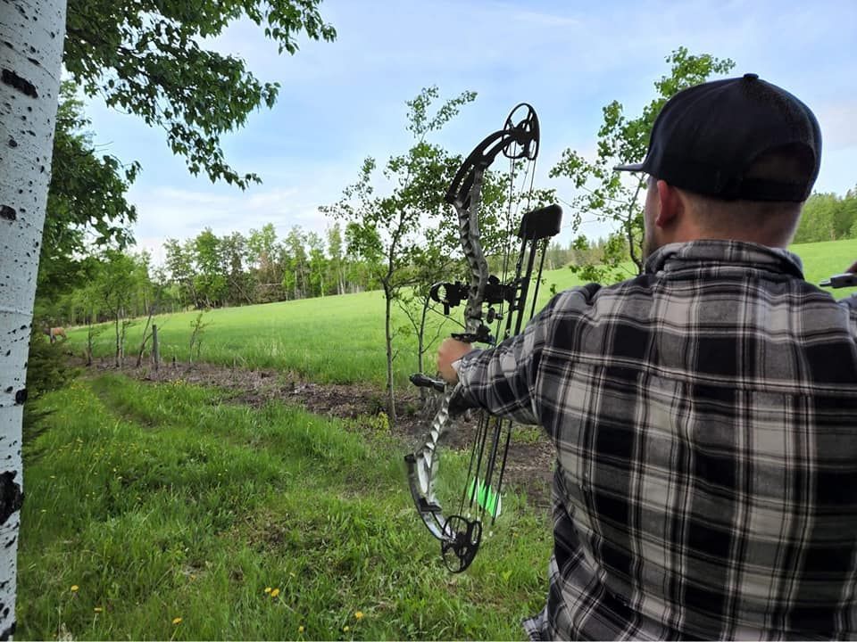 Man shooting arrow at target