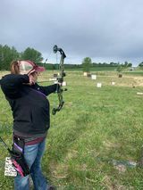 Archer shooting arrow at target