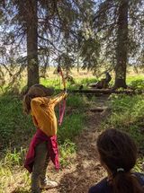 Archer shooting arrow at target