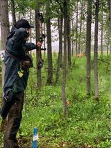 Man shooting arrow at target