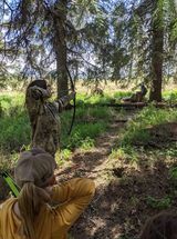 Archer shooting arrow at target