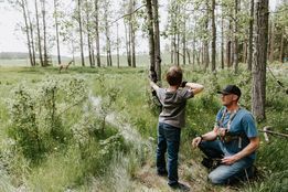 Boy shooting at target