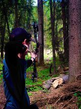 Man shooting arrow at target