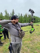 Man shooting arrow at target