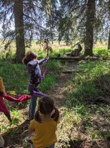 A group of children are playing in the woods.
