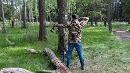 Archer shooting arrow at target