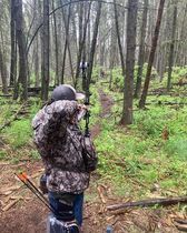 Archer shooting arrow at target