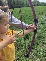 Young archer getting ready to shoot an arrow