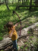 Young girl shooting arrow