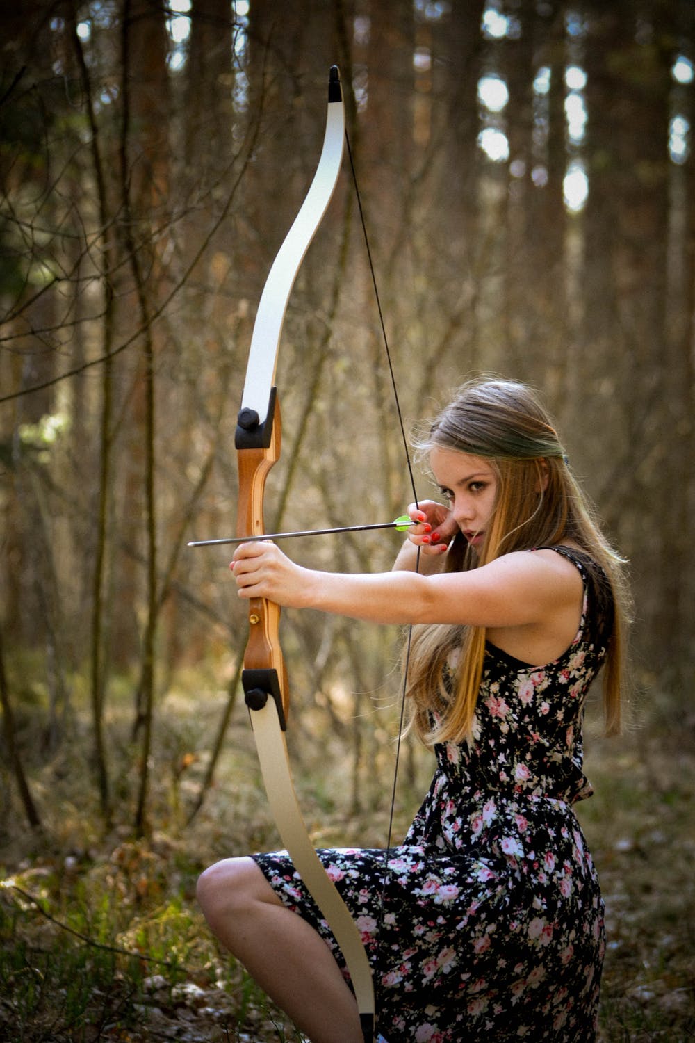 Archery shooting an arrow at a field target.