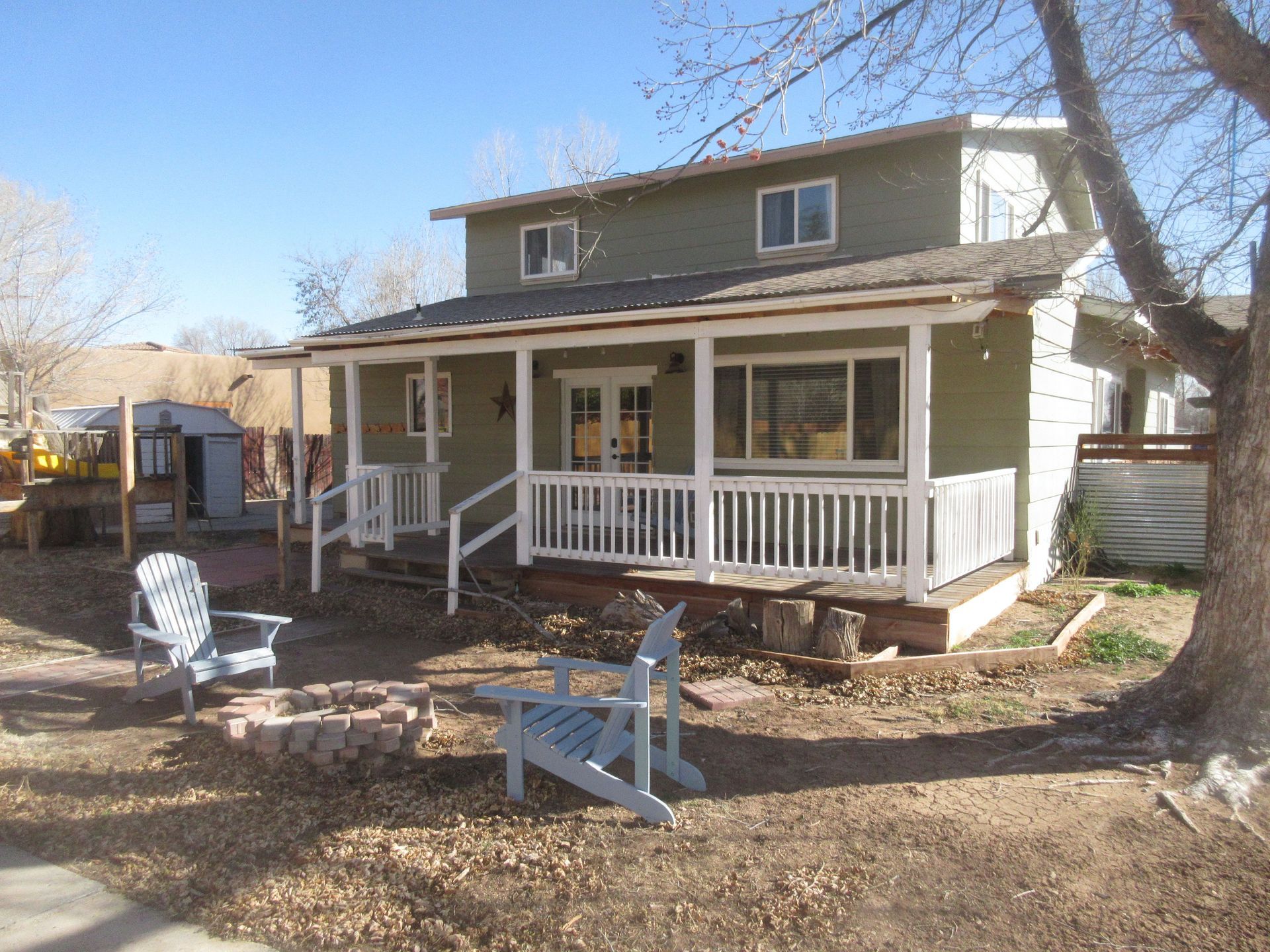 A house with a porch and chairs in front of it