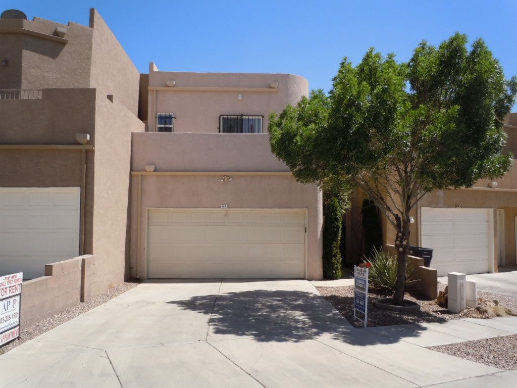 A house with a sign that says ' for sale ' on it