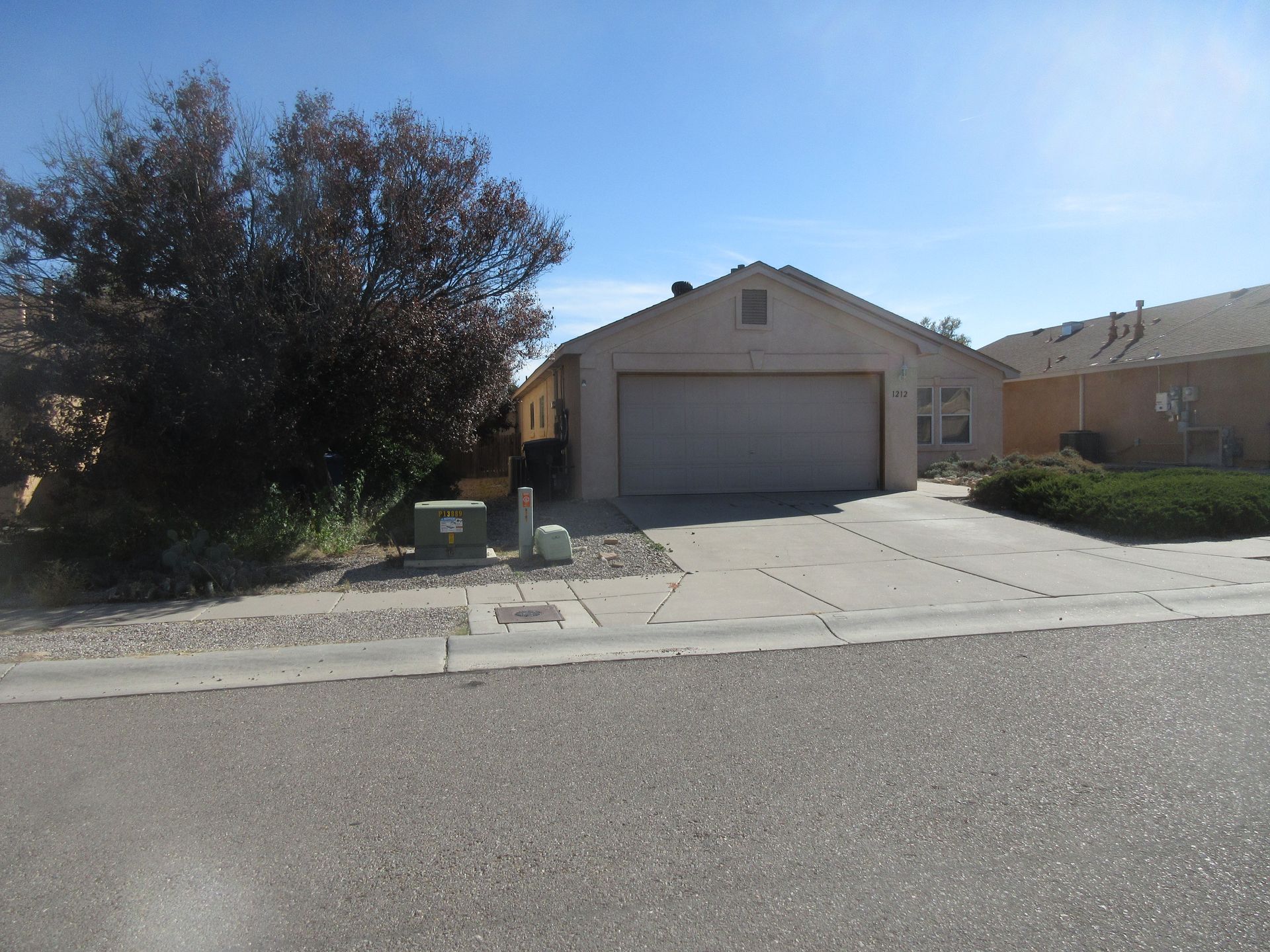 A house with a garage and a driveway in front of it