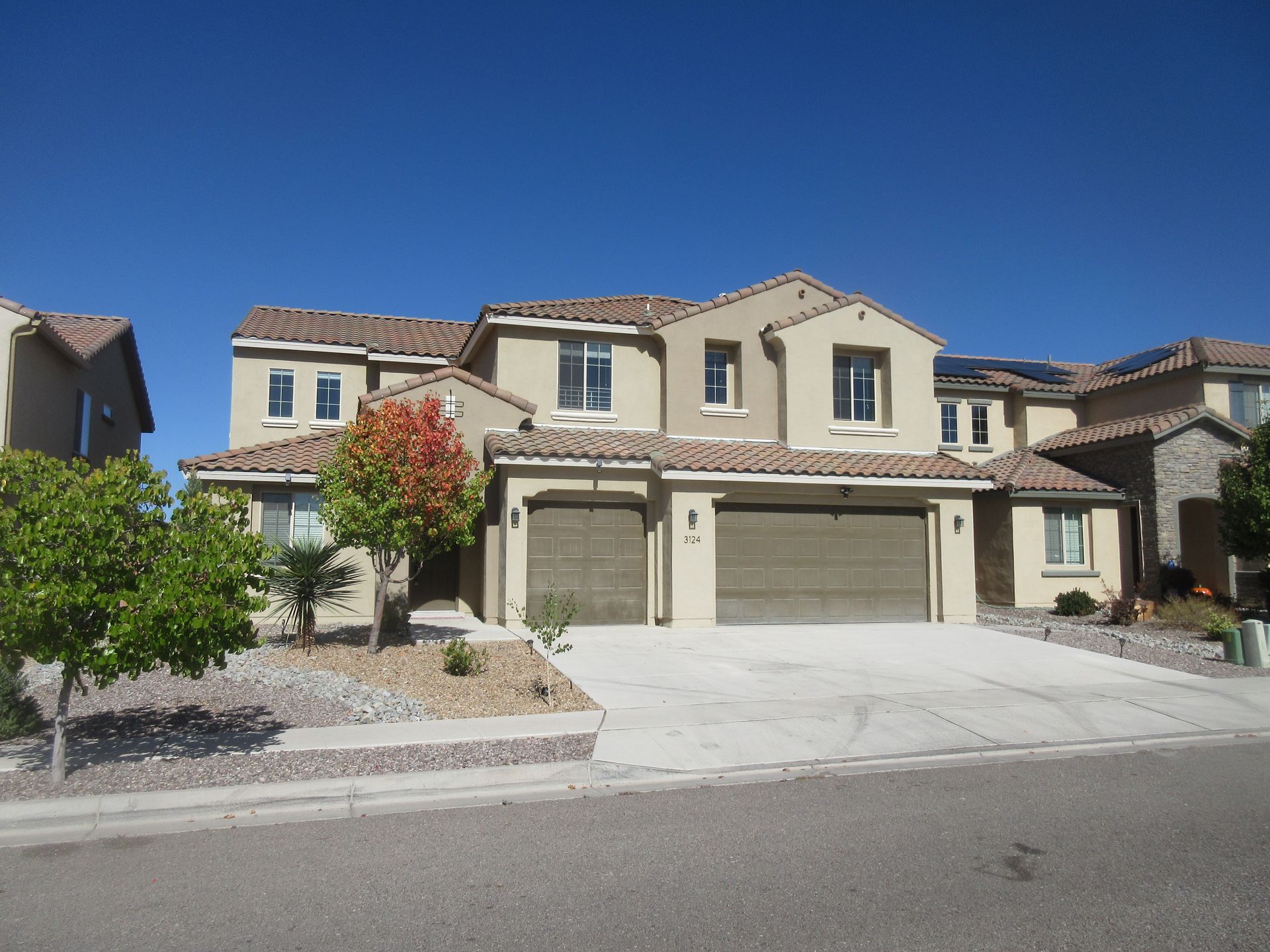 A large house with two garages and a driveway