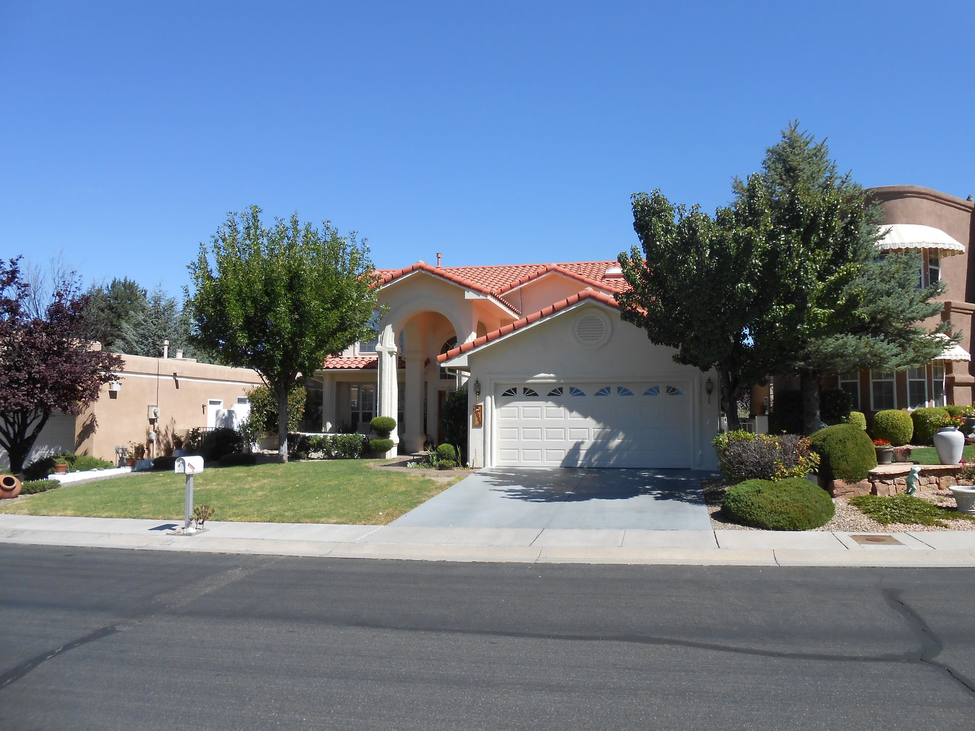A large white house with a red tile roof