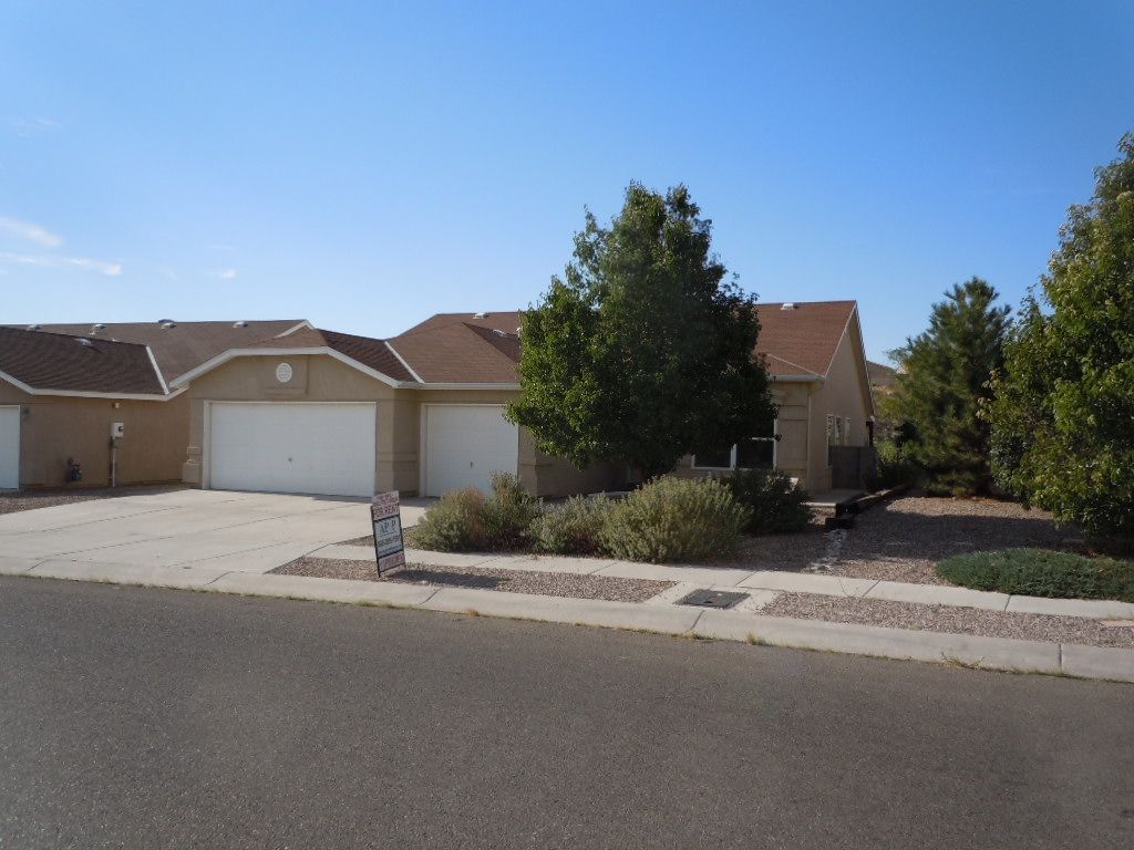 A house with a for sale sign in front of it