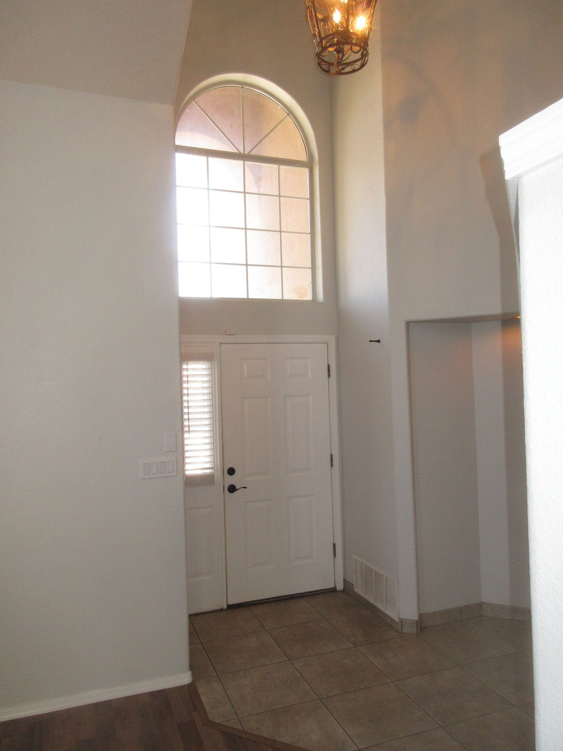 An empty room with a door and a window