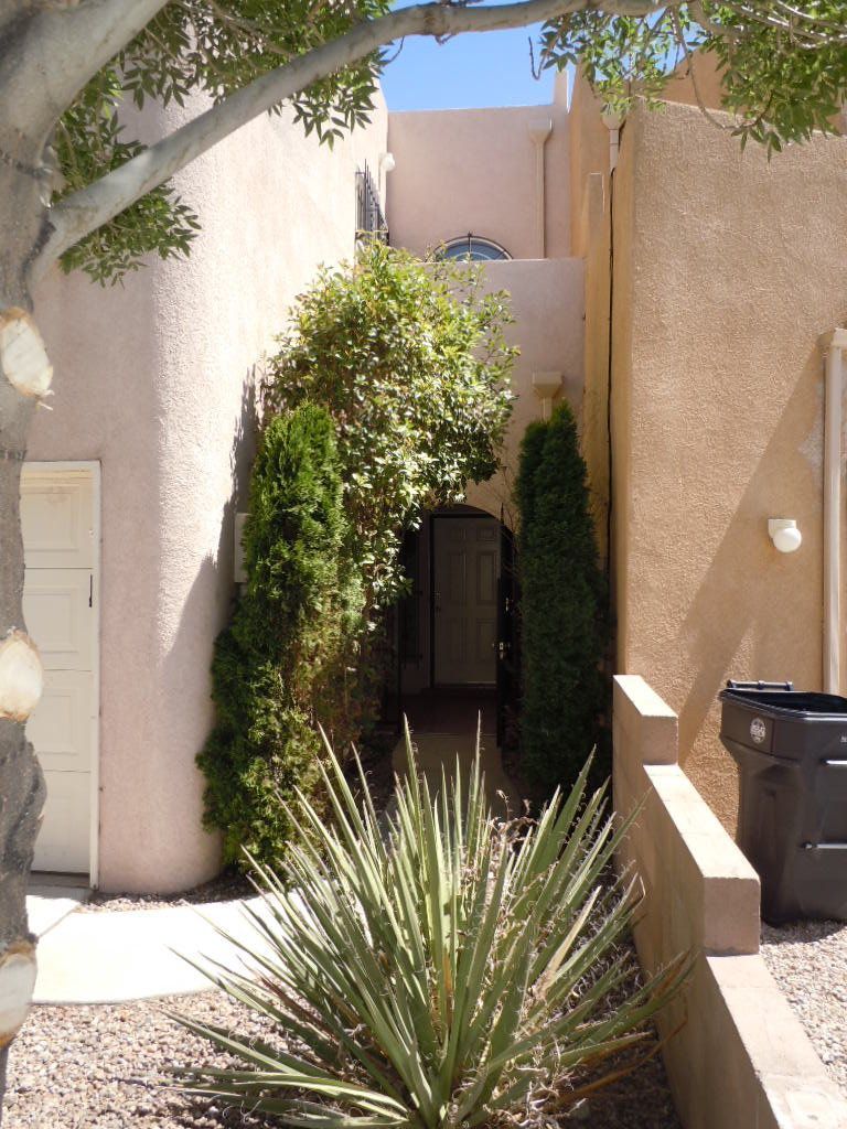 A house with a trash can in front of it