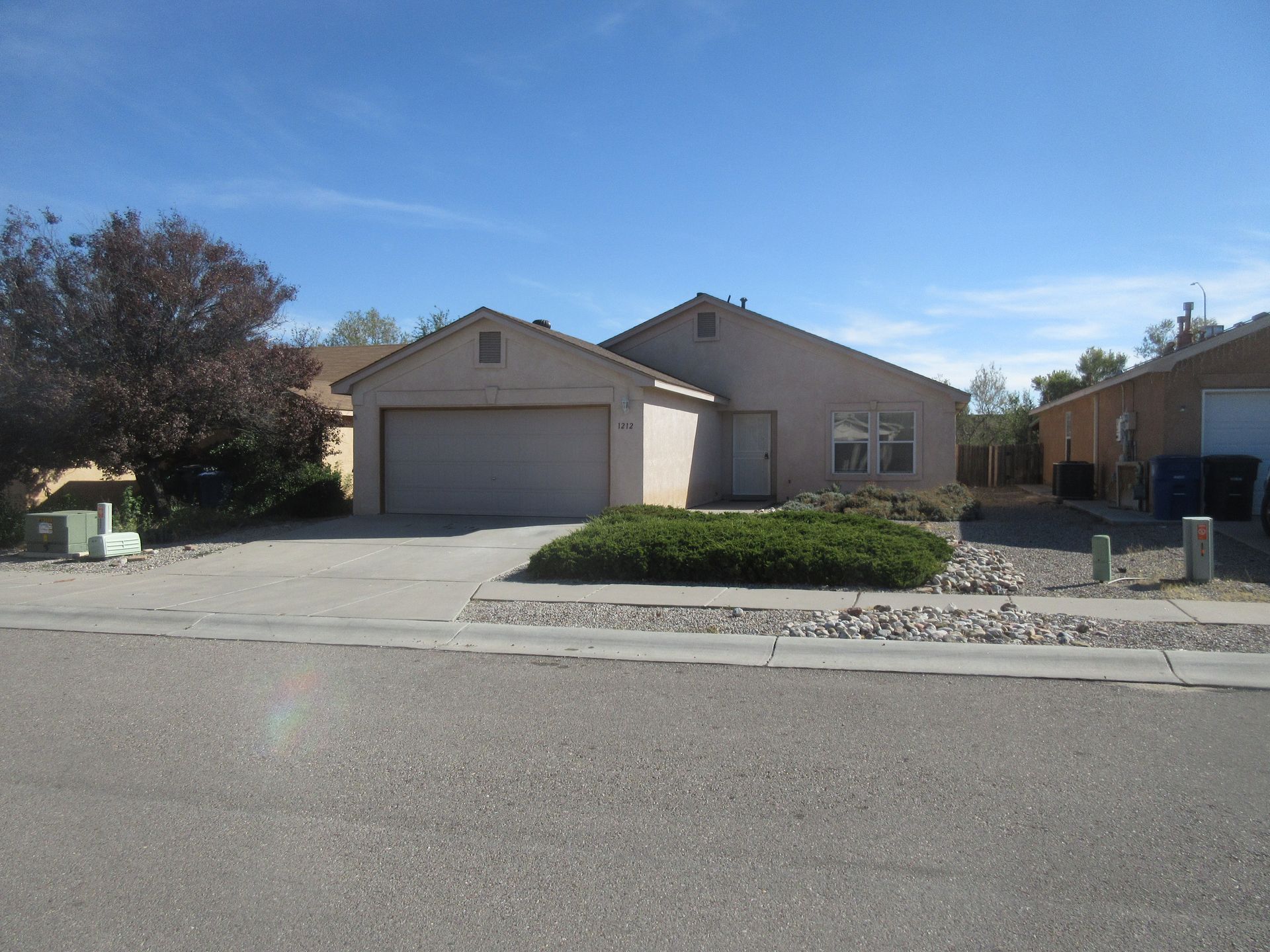 A house with a garage and a driveway in front of it