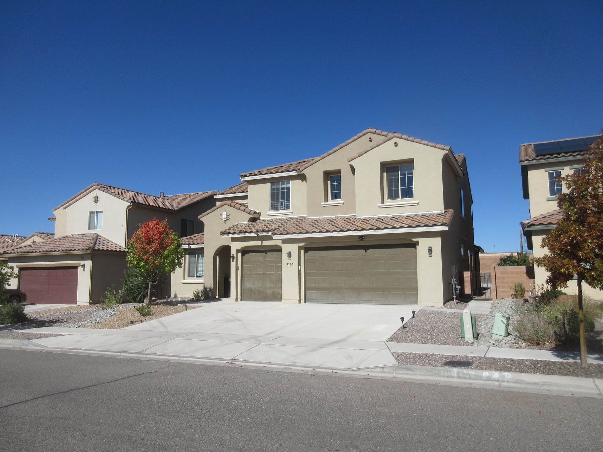 A large house with two garages and a driveway