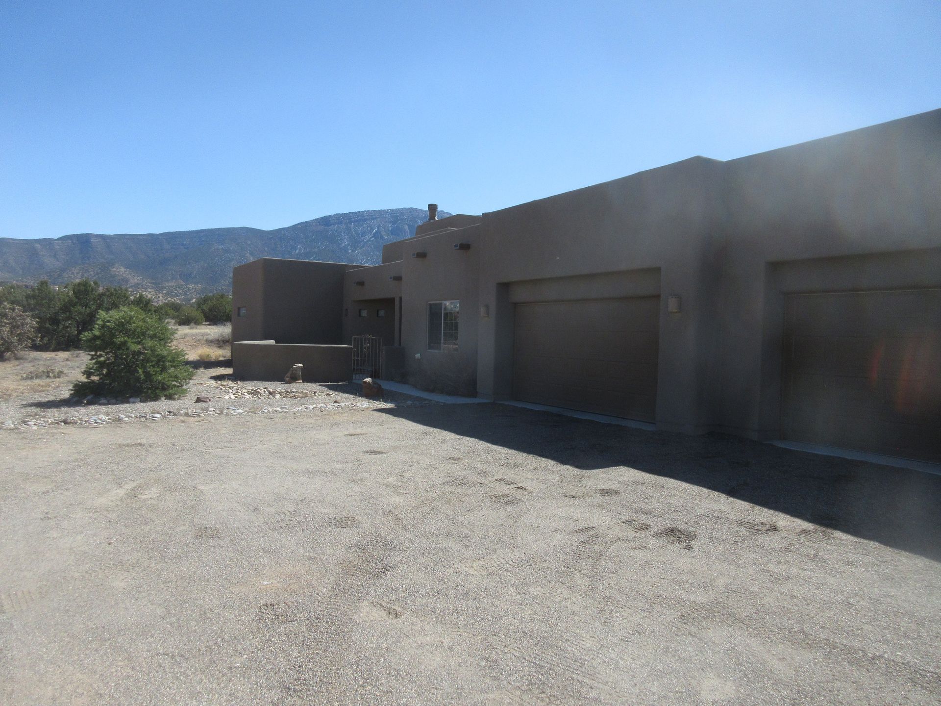 The outside rear view of a rental property in Placitas, NM with Advantage Pointe Properties that is 3BDR/2BA/3CG