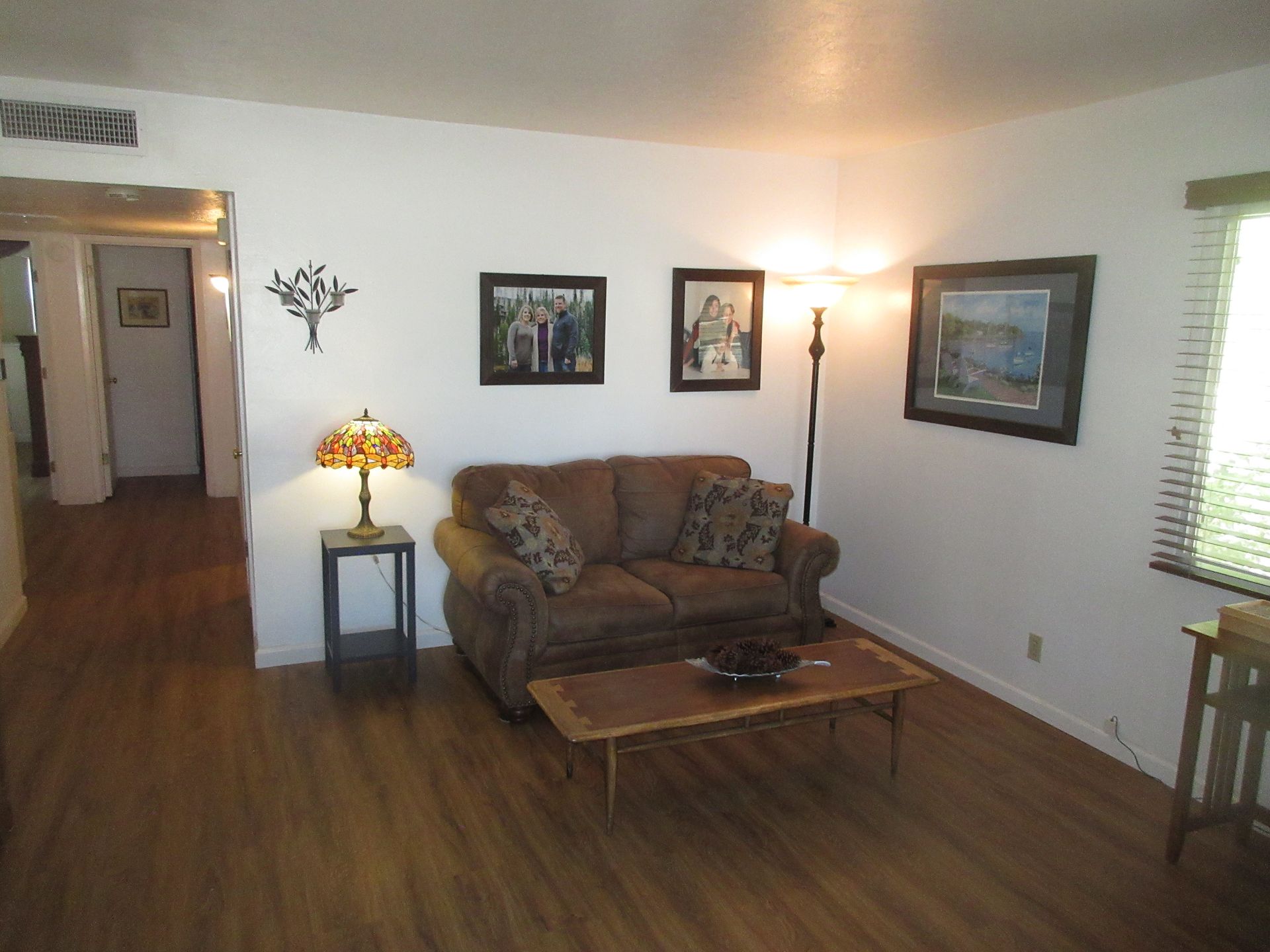 A living room with a couch and a lamp