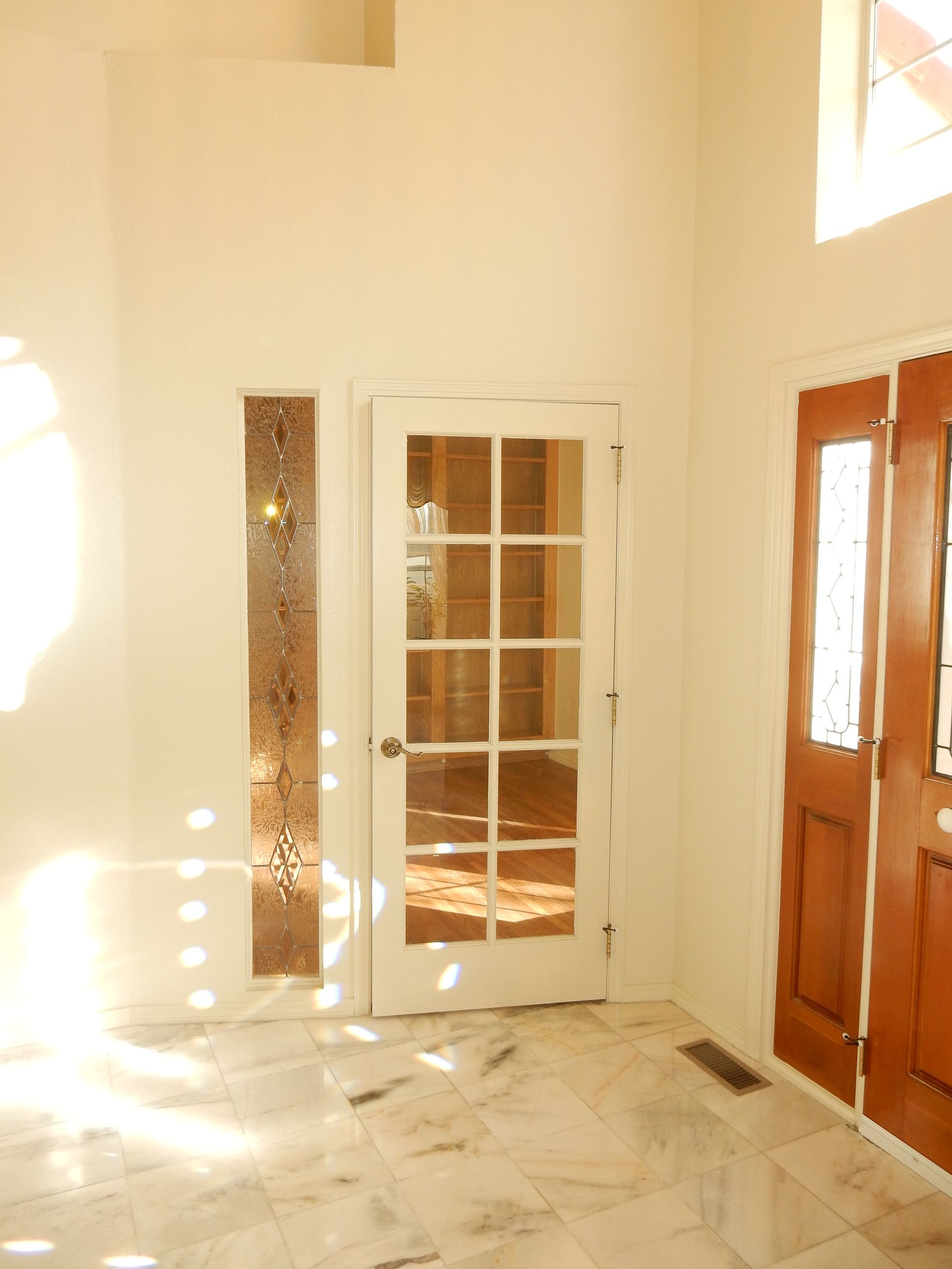 An empty room with a door and a window