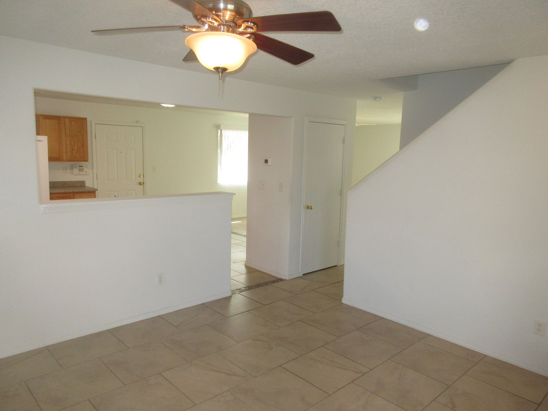 An empty room with a ceiling fan and a light