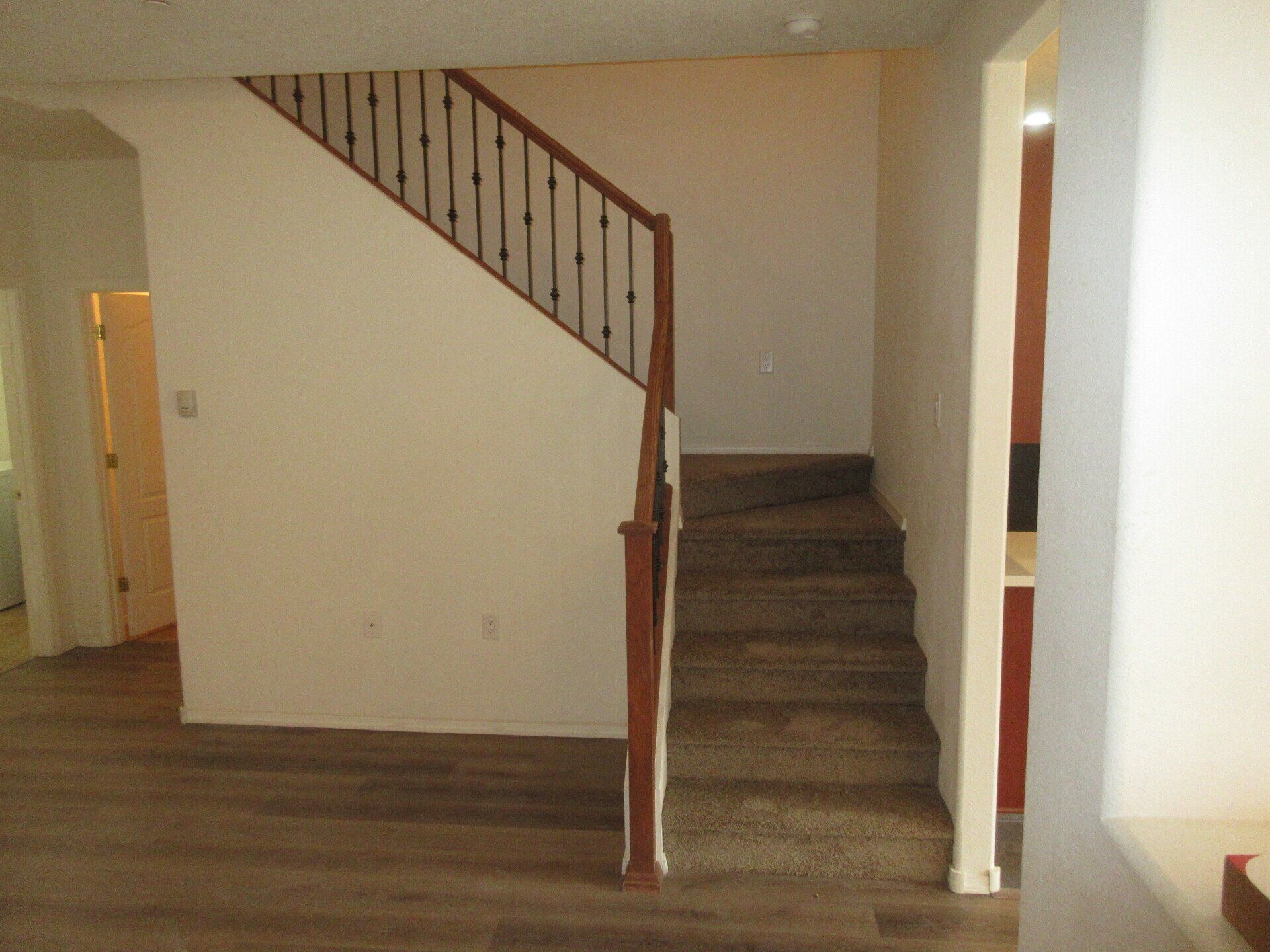 An empty house with stairs leading up to the second floor