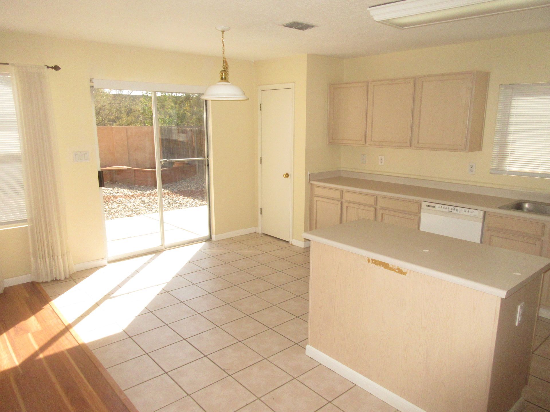 An empty kitchen with a sliding glass door