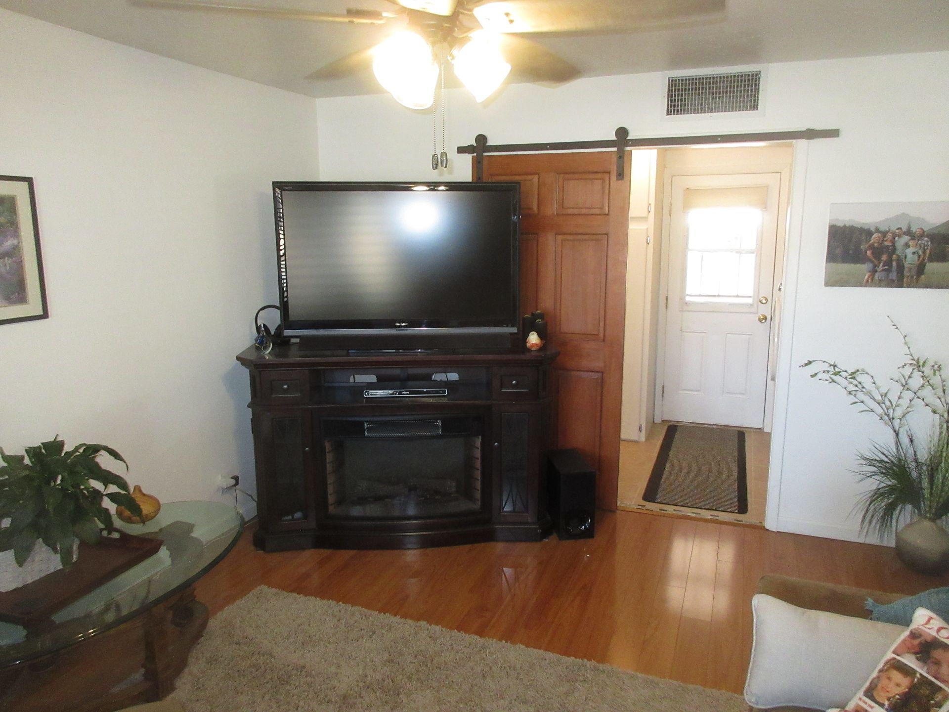 A living room with a flat screen tv and a fireplace
