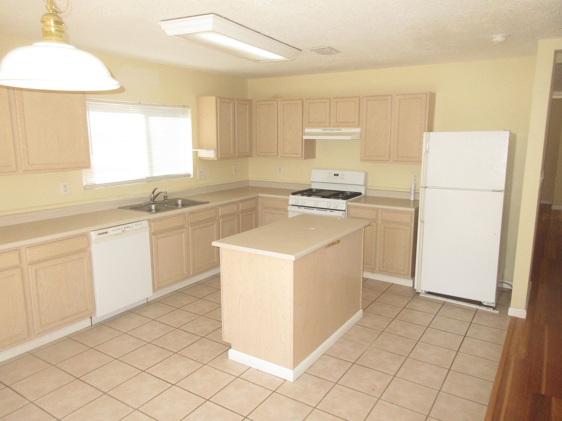 A kitchen with wooden cabinets and a white refrigerator