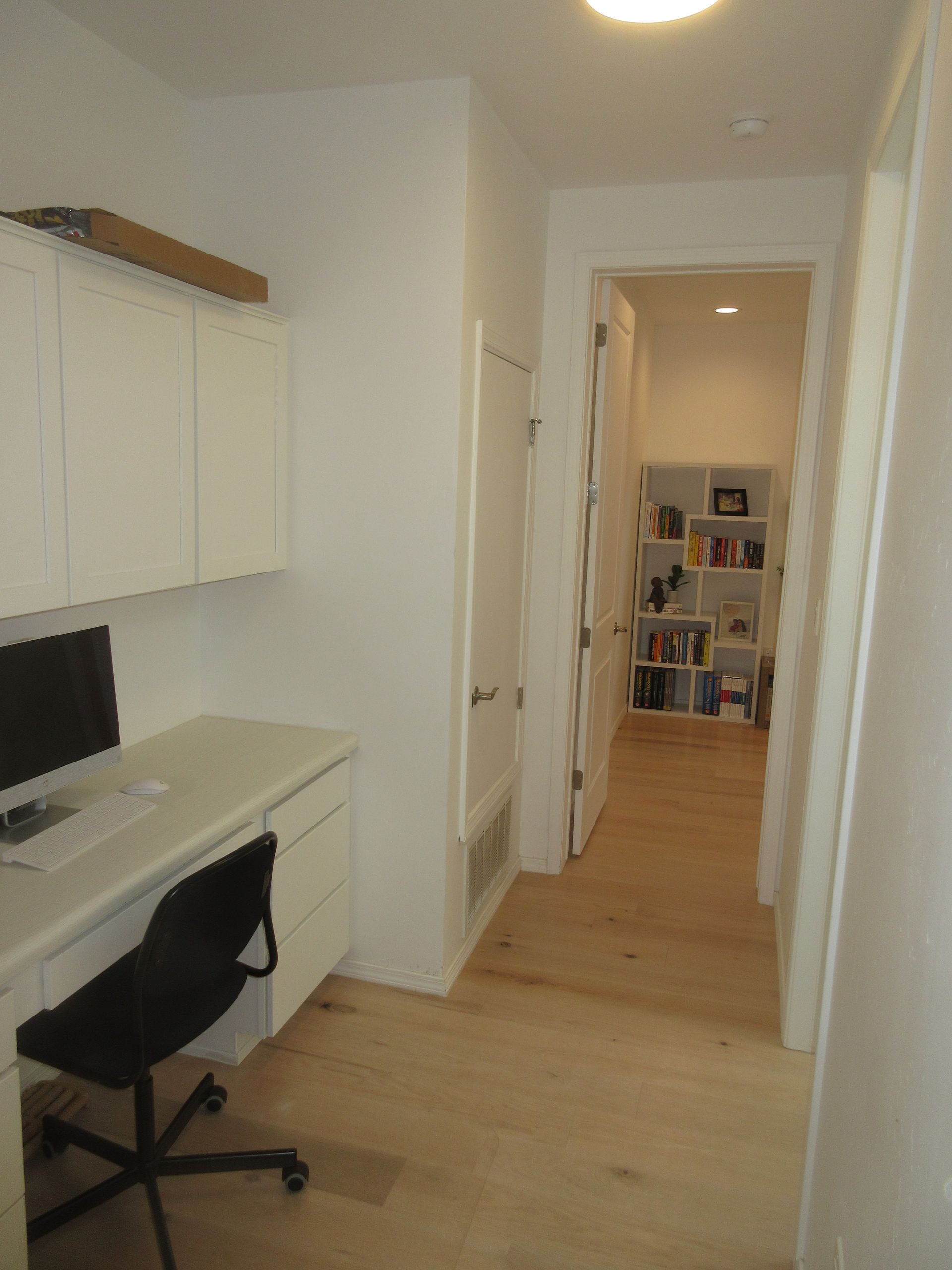 A room with a desk and chair and a bookshelf